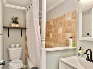 a bathroom with a toilet and a shower curtain at Downtown Condo! Private Balcony! PT10F in Atlanta +14 photos