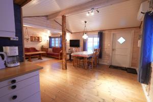 a kitchen and living room with a table in a room at Little Paradise in Morfjorden