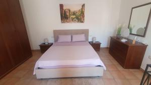 a bedroom with a large bed and two night stands at Ferienhaus Casa Silenzio in Mandatoriccio