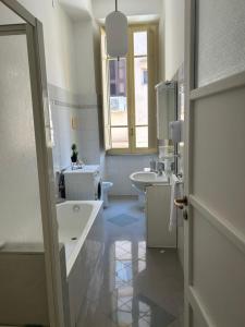 a white bathroom with two sinks and a tub at Casa mediterranea in Formia