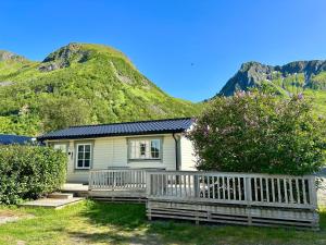 a small house with a mountain in the background at Little Paradise in Morfjorden