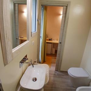 a bathroom with a white sink and a toilet at Casa di Minnanni B&B in Santa Teresa Gallura +34 photos