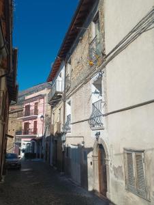 an alley with buildings and a car on a street at Antiche Mura in Celano