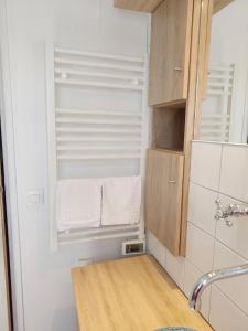 a small bathroom with a sink and white towels at La Salagnac in Corrèze +90 photos