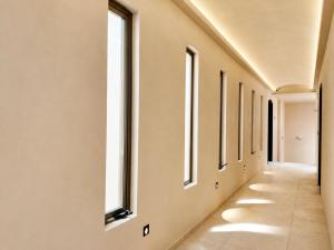 a corridor in a hospital with windows at The Sanctuary Boutique Hotel in Tangolunda +20 photos