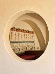 a room with a wall with a painting of people at The Sanctuary Boutique Hotel in Tangolunda