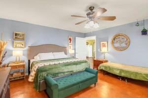 a bedroom with a bed and a couch and a ceiling fan at Three Horses Ranch in Johnson City +70 photos