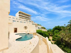 an image of a resort with a slide and a swimming pool at The Sanctuary Boutique Hotel in Tangolunda