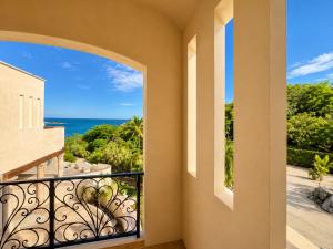 a balcony with a view of the ocean at The Sanctuary Boutique Hotel in Tangolunda
