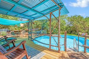 a pool with a swing and chairs on a deck at Three Horses Ranch in Johnson City