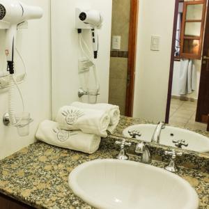 a bathroom with a sink and a mirror and towels at Inti Masi in Salta