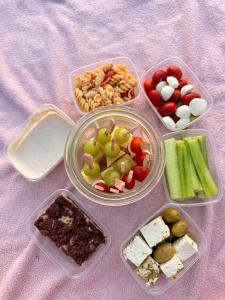 four plastic containers filled with different types of food at Acorn Creek Tented Camp in Nidda