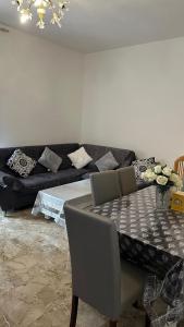a living room with a table and a couch at Thind house in Brescia
