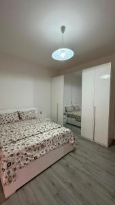 a bedroom with a large bed and a light at Thind house in Brescia +2 photos