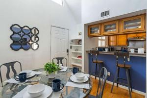 a dining room with a glass table and a kitchen at Spacious Austin Loft 4BR Sleeps 12 in Austin +39 photos
