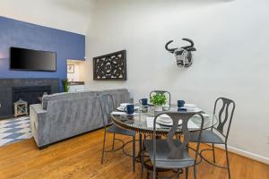 a living room with a table and a couch at Spacious Austin Loft 4BR Sleeps 12 in Austin