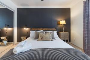 a bedroom with a large bed with white sheets and pillows at Spacious Austin Loft 4BR Sleeps 12 in Austin