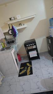 a kitchen with a counter and a table with food at Cedar Suites in Juja