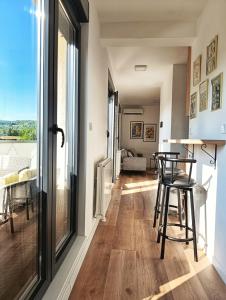 a kitchen and living room with a table and chairs at "Dolce Vita" Loft in Tuzla