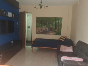 a living room with a couch and a painting on the wall at La Esquina in Esquel