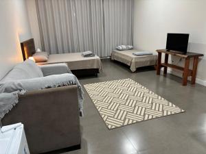 a living room with a couch and a rug at Apartamento casa da Lu 102 in Primavera do Leste