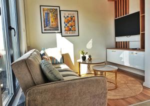 a living room with a couch and a table at "Dolce Vita" Loft in Tuzla