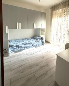 a bedroom with a bed and a wooden floor at Thind house in Brescia