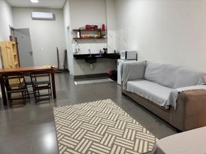a living room with a couch and a table at Apartamento casa da Lu 102 in Primavera do Leste