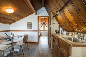 a kitchen with a sink and a table with chairs at The Shoreline Tofino in Tofino +157 photos
