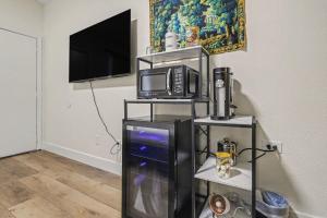 a living room with a tv and a microwave at The Warren Hotel in Bridgman