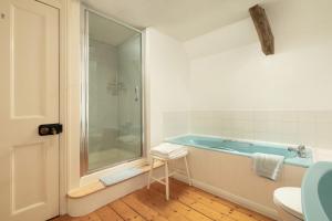 a bathroom with a tub and a toilet and a sink at Parnacott in Pancrasweek +55 photos