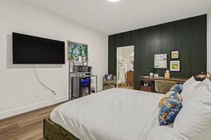 a bedroom with a large bed with a flat screen tv at The Warren Hotel in Bridgman