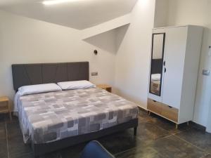 a bedroom with a bed and a chair in it at Country House Villa Marezi in Cupra Marittima