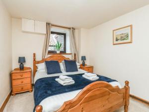 a bedroom with a large wooden bed with blue pillows at Owl in Pickering +62 photos