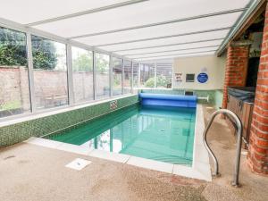 an indoor swimming pool in a building with windows at Owl in Pickering