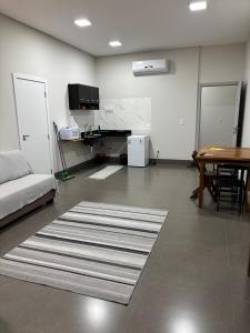 a living room with a table and a rug at Apartamentos casa da Lu 101 in Primavera do Leste