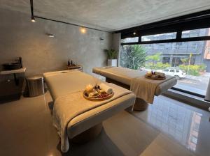 a room with two beds and a table with candles at Hostal Joy Calle 85 in Bogotá