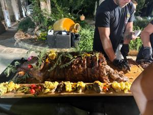 a man standing next to a table with a steak at Casolare Lodedo in Ceglie Messapica