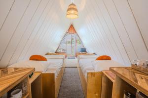 a row of beds in a room with a window at The Shoreline Tofino in Tofino