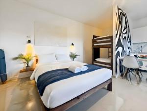 a bedroom with a large bed and a bunk bed at Hatton - 650m do plaży ! in Grzybowo