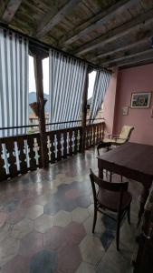 a room with a table and chairs and windows at Antica osteria in Primaluna +22 photos