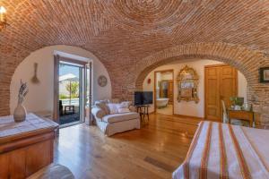 a living room with a brick wall at Domus Sa Corbula in Oristano
