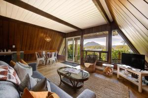 a living room with a couch and a tv and a table at The Shoreline Tofino in Tofino