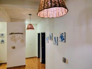 a room with two lamps and a wall with pictures at Comfortable apartment close to beaches and plazas in Santa Cruz Huatulco