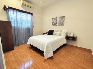 a bedroom with a bed and a large window at Comfortable apartment close to beaches and plazas in Santa Cruz Huatulco +6 photos