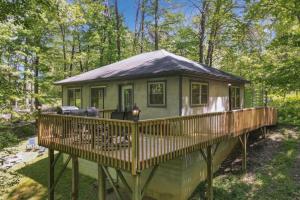 a house on a deck in the woods at Honey Ridge Forest Retreat in South Bloomingville +7 photos