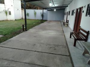 a hallway with two benches and a building at Alojamiento Ruta 51 in La Banda