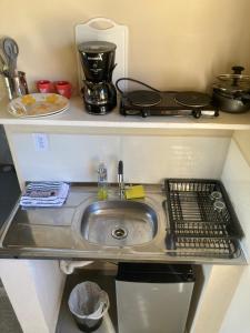 a kitchen counter with a sink and a stove at Paraitinga Glamping in São Luiz do Paraitinga +21 photos