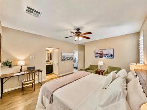 a bedroom with a bed and a ceiling fan at Amazing Grace Vacation Home in Las Vegas +37 photos