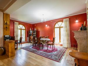 a dining room with red walls and a table and chairs at guest hause "villa" in Dushetʼi